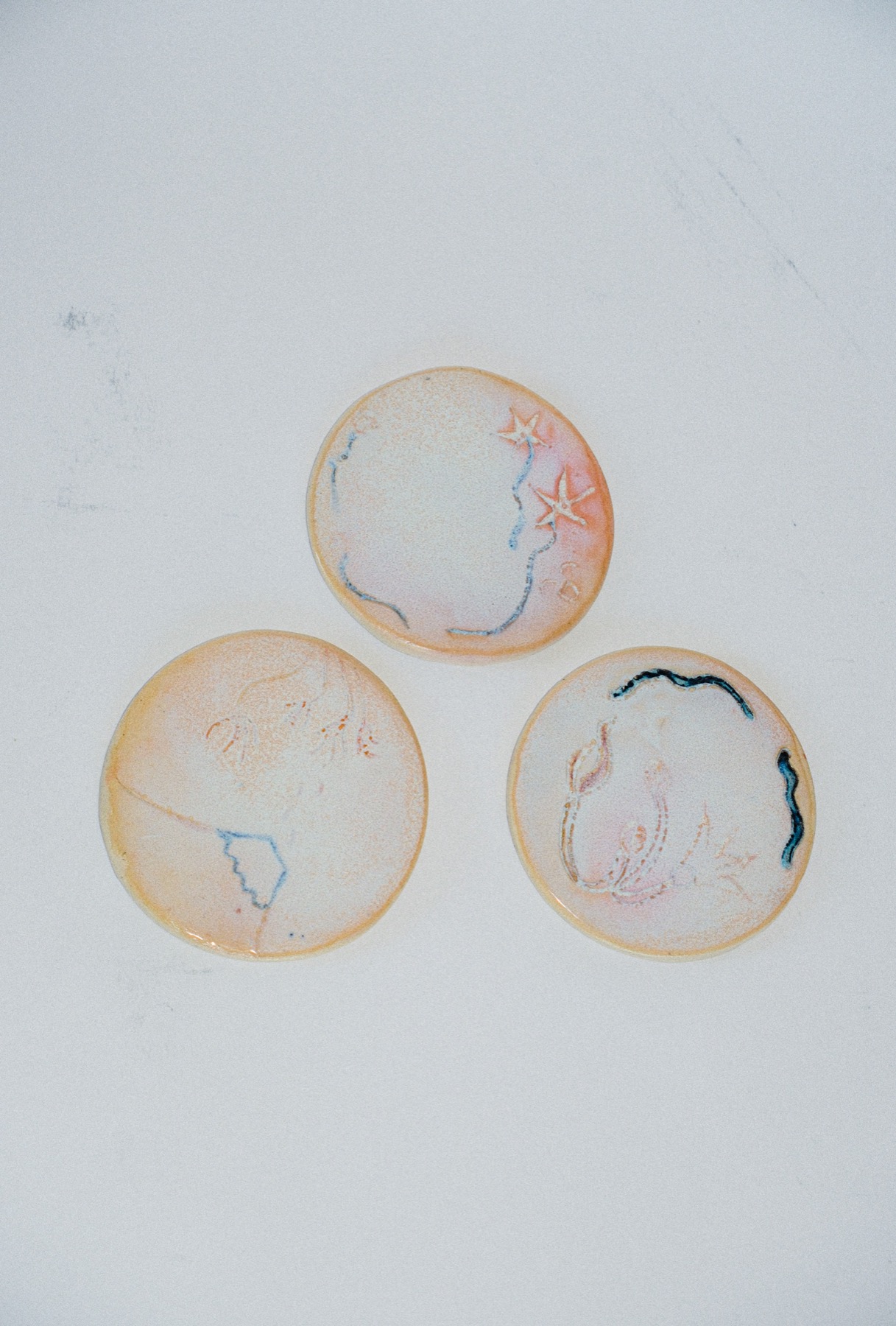 Three small ring dishes with fine line etching