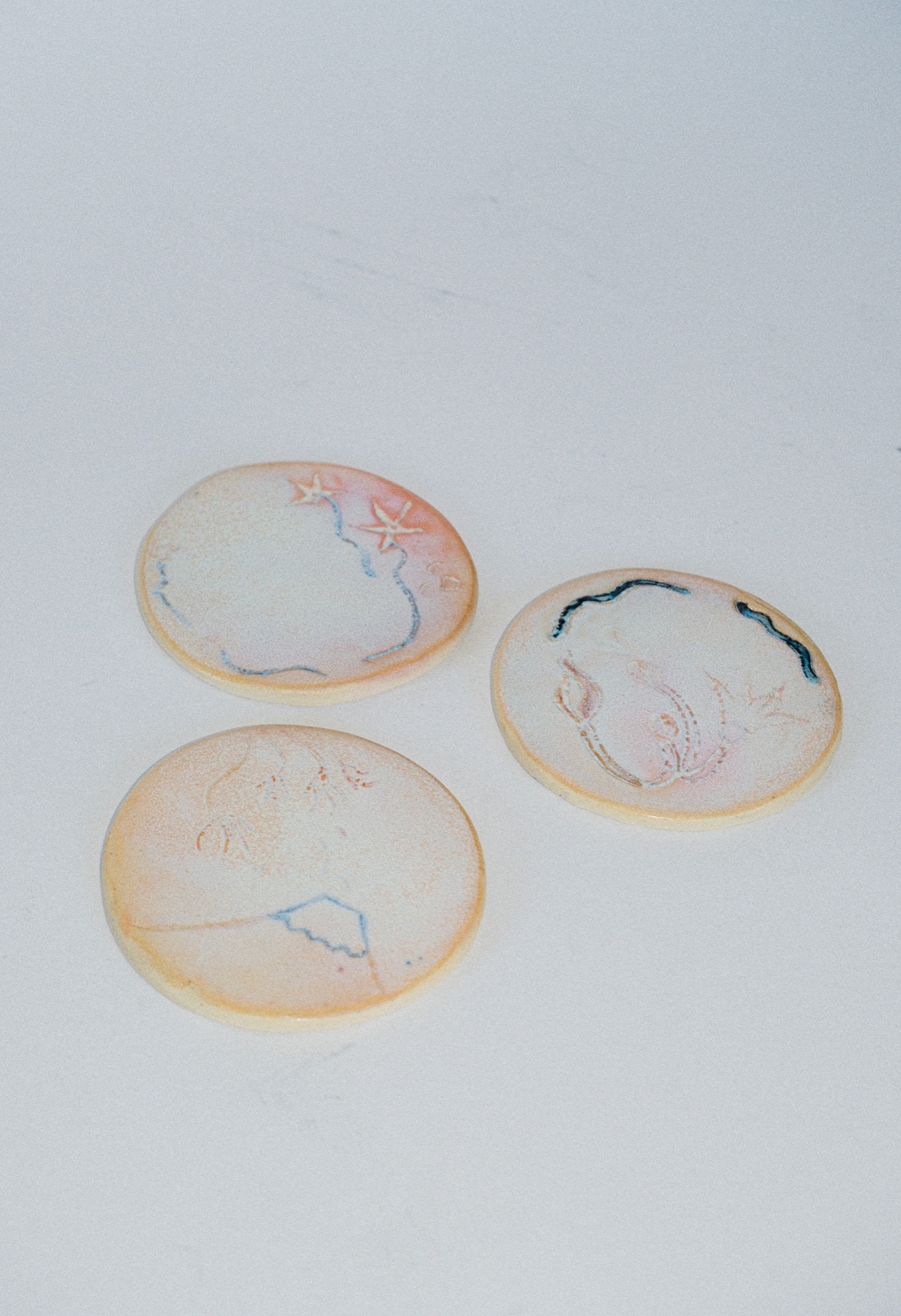 Three more small ring dishes with fine line etching