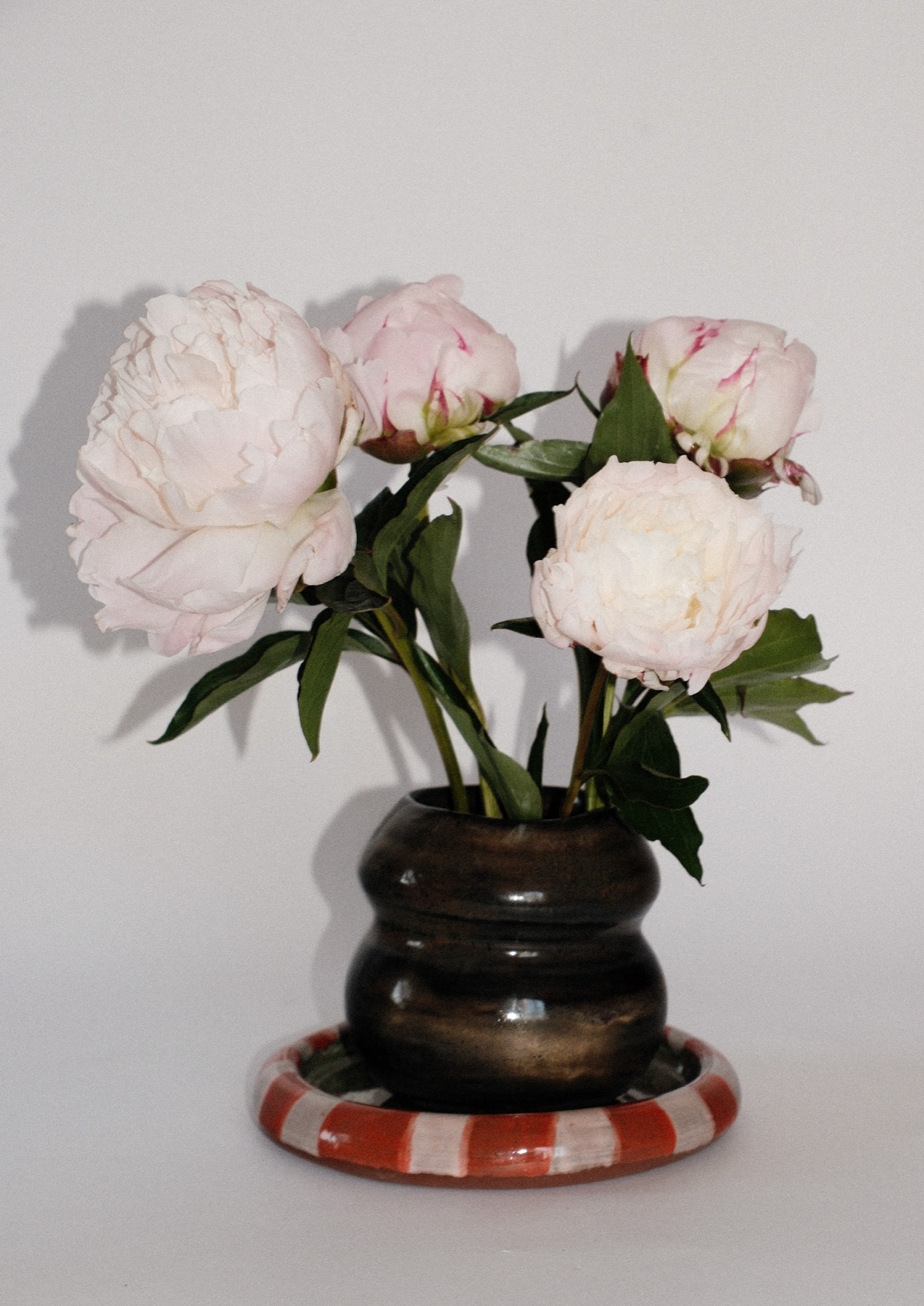 Dark glazed two-tier vase with peonies
